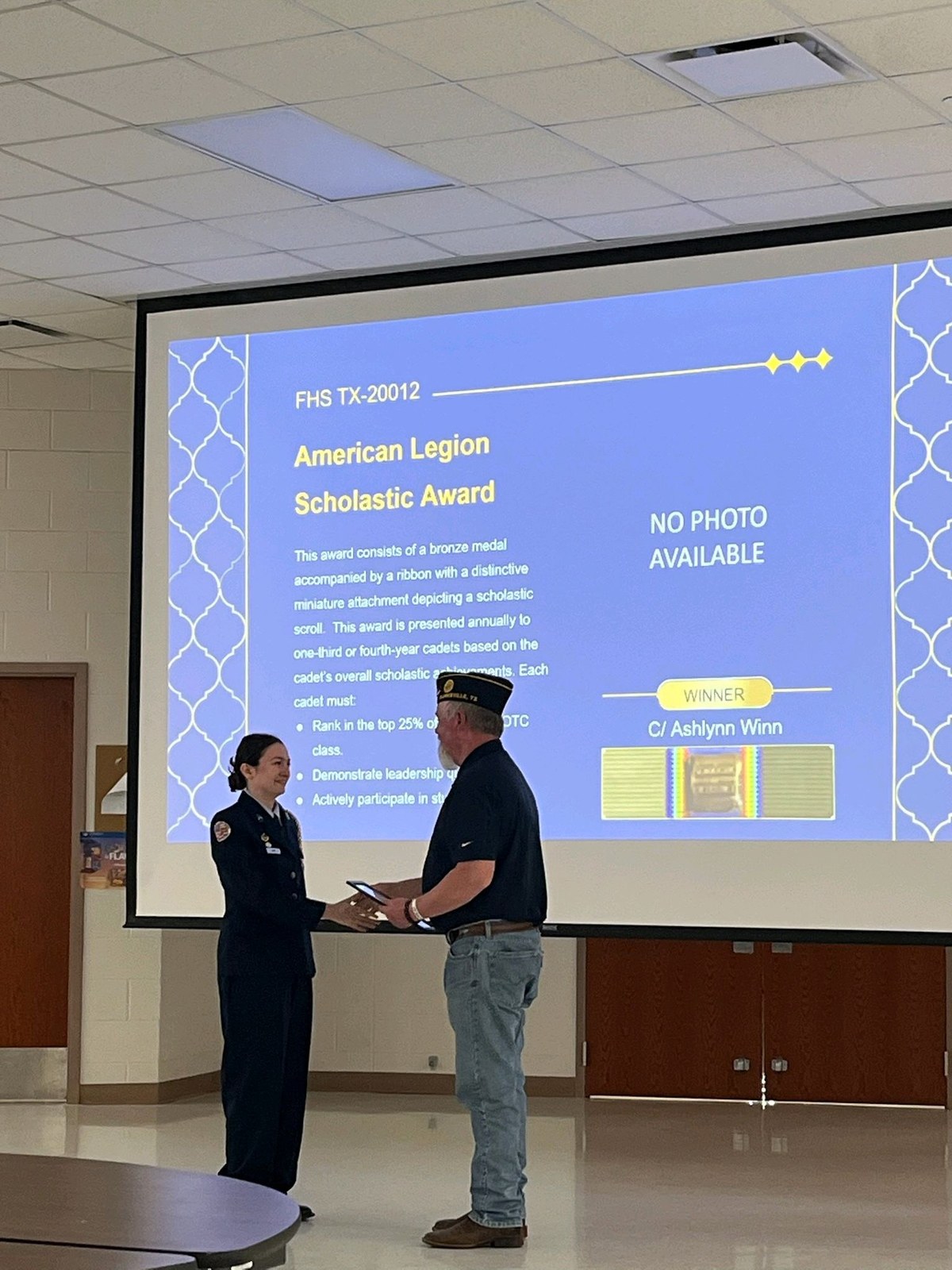 Commander Jared Shaw presents American Legion Scholastic Award to Cadet Ashlynn Winn